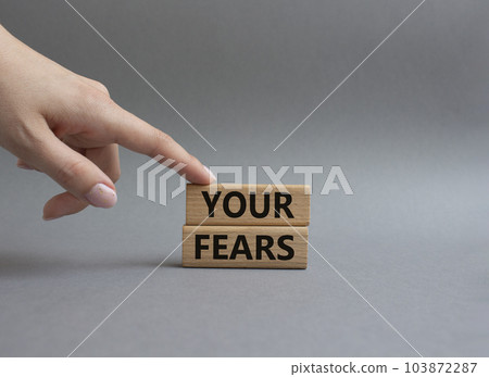 Your fears symbol. Wooden blocks with words Your fears. Beautiful grey background. Businessman hand. Business and Your fears concept. Copy space. 103872287