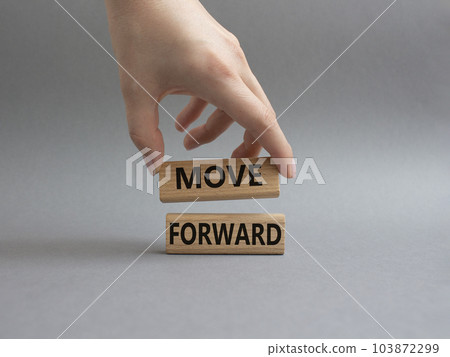 Move forward symbol. Wooden blocks with words Move forward. Beautiful grey background. Businessman hand. Business and Move forward concept. Copy space. 103872299