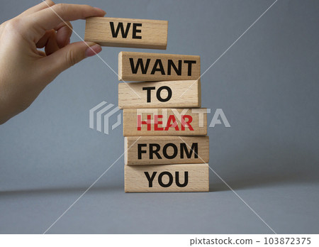 We want to hear from you symbol. Wooden blocks with words We want to hear from you. Beautiful grey background. Businessman hand. Business and We want to hear from you. Copy space. 103872375