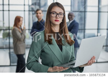 Portrait, Professional and confident millennial businesswoman or female executive manager in formal suit and eyeglasses 103873134