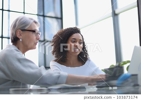 Female colleagues of different nationalities and ages met in the office hall 103873174