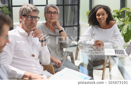 discussion of business people in the office sitting at the table discussion of business people in the office sitting at the table 103873191