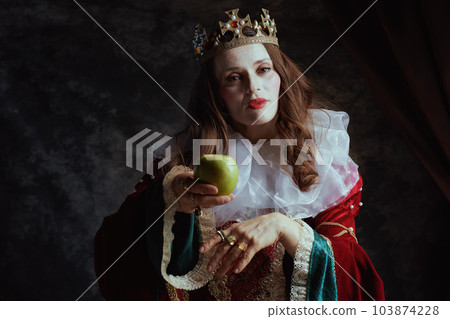 medieval queen in red dress with green apple and white collar 103874228
