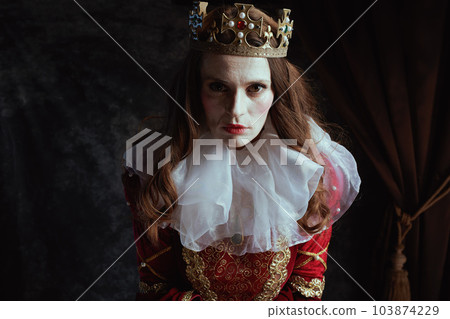 scary medieval queen in red dress with white collar and crown scary medieval queen in red dress with white collar and crown 103874229