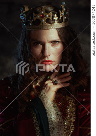medieval queen in red dress with crown 103874243