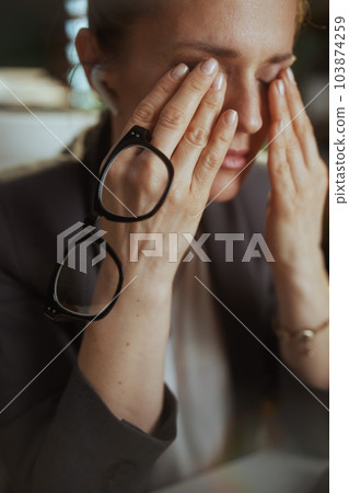 tired modern small business owner woman at work with eyeglasses tired modern small business owner woman at work with eyeglasses 103874259