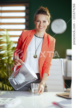 Portrait of smiling business owner woman in green office Portrait of smiling business owner woman in green office 103874266