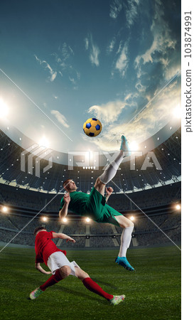 Dynamics. Two male sportsmen, football players in motion during competition, playing at 3D openair stadium, kicking ball Dynamics. Two male sportsmen, football players in motion during competition, playing at 3D openair stadium, kicking ball 103874991