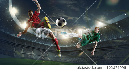 Dynamic image of competitive, motivate football players in a jump, kicking ball during game at 3D playground area with flashlights Dynamic image of competitive, motivate football players in a jump, kicking ball during game at 3D playground area with flashlights 103874996