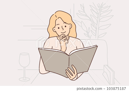 Successful woman restaurant visitor reads menu sitting at table with empty wine glas 103875187