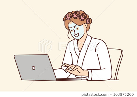 Woman internet troll and hater uses laptop sitting at home with mask on face and in curlers 103875200