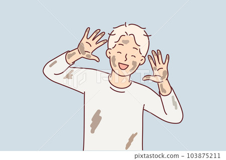 Cheerful dirty boy pre-adolescent age laughs and shows palms and face stained with clay from puddle Cheerful dirty boy pre-adolescent age laughs and shows palms and face stained with clay from puddle 103875211