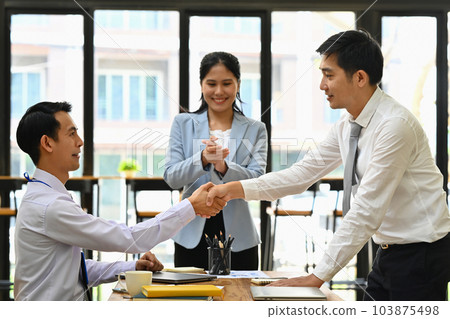 Businesspeople shaking hands closing deal or after successful negotiations at meeting 103875498