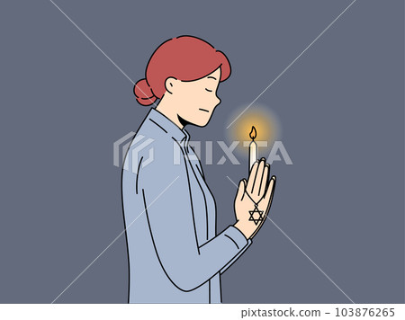 Praying jewish woman with burning candle in hand for international holocaust remembrance day concept Praying jewish woman with burning candle in hand for international holocaust remembrance day concept 103876265