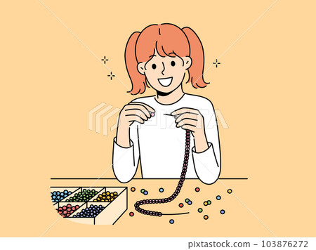 Little girl weaves beaded jewelry sitting at table and creating handmade necklace or bracelet Little girl weaves beaded jewelry sitting at table and creating handmade necklace or bracelet 103876272