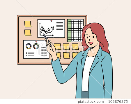 Businesswoman demonstrates financial graphs and charts pinned on cork board in office 103876275