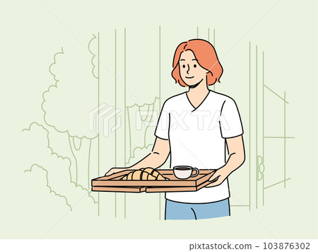 Woman wants to have breakfast in garden or in backyard carries tray of hot tea and croissants. Woman wants to have breakfast in garden or in backyard carries tray of hot tea and croissants. 103876302