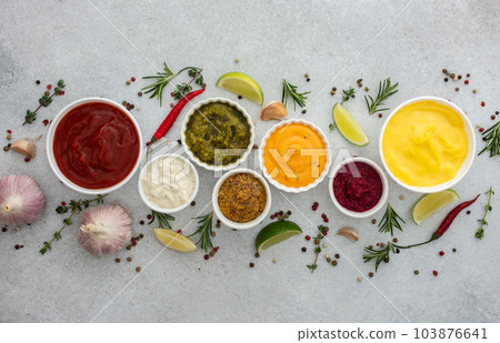 Different types of sauces in bowls 103876641
