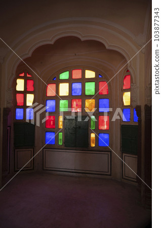 Colourful small windows, interiors of the Hawa Mahal (Wind Palace), is a palace built from red and pink sandstone, Jaipur, Rajasthan, India 103877343