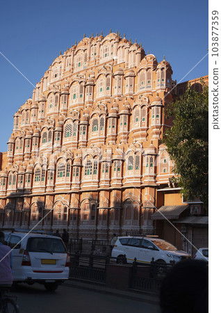 Exteriors of the Hawa Mahal or Wind Palace, built from red and pink sandstone. It is akin to a honeycomb with its 953 small windows called Jharokhas decorated with intricate latticework, Jaipur, Exteriors of the Hawa Mahal or Wind Palace, built from red and pink sandstone. It is akin to a honeycomb with its 953 small windows called Jharokhas decorated with intricate latticework, Jaipur, 103877359