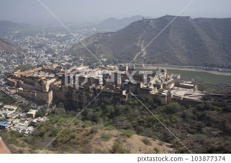 View of Amer Fort, boundary walls and Jaipur city from Jaigarh Fort situated on Cheel ka Teela or Hill of Eagles of the Aravalli range, it overlooks the Amer Fort and the Maota Lake, near Amer Jaipur, 103877374