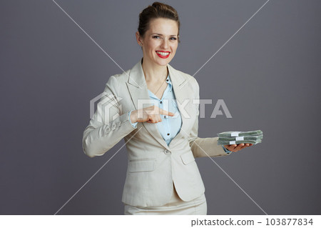 smiling trendy woman worker in light business suit 103877834