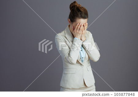 stressed young female employee in light business suit 103877848