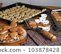 Food background with homemade cookies. The process of making cookies in the kitchen with dough and molds. 103878428
