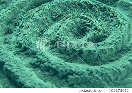 Chlorella or spirulina algae green powder is spinning, rotation. Dietary supplement to improve health. Seaweed superfood. Healthy food background. Vitamins and minerals to diet. Detox. Close up 103878612