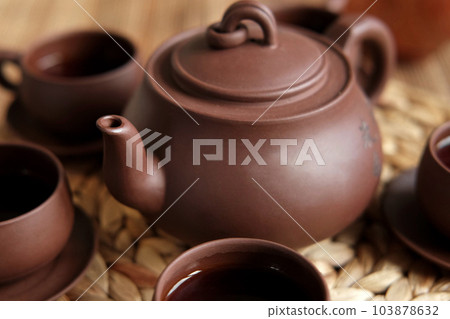 Tea Ceremony. Traditional Asian Tea Utensil, Serving Authentic Set. Person Pouring Tea from Brown Pottery Teapot to Teacup. Bamboo Tray. Lifestyle. Wellness Balance Health. Tea Brewing Equipment 103878632