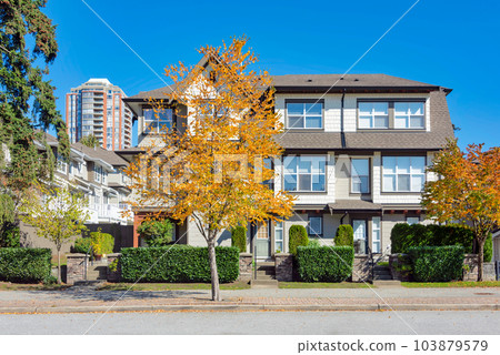 Residential apartment buildings on blue sky background Residential apartment buildings on blue sky background 103879579