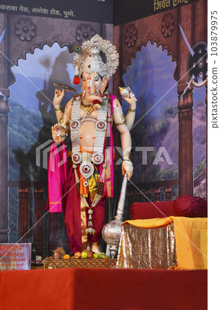 Standing Ganesha murti, Hindu Lord of Success, statue in a pandal during Ganesh Utsav festival at Pune, Maharashtra... Standing Ganesha murti, Hindu Lord of Success, statue in a pandal during Ganesh Utsav festival at Pune, Maharashtra... 103879975