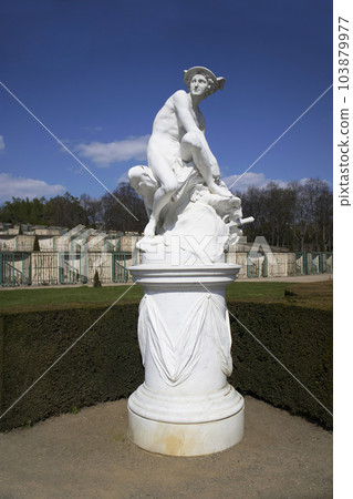 Marble statue of Mercury by Jean Baptiste Pigalle on the side of the large fountain built in the center of the garden, Sansouci Palace, Potsdam, Germany.. 103879977