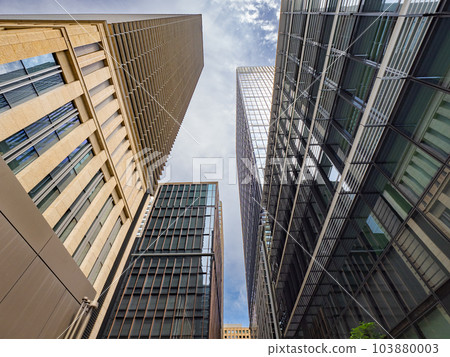 Urban landscape of Marunouchi, Tokyo Looking up at the narrow sky from between buildings in the office district Urban landscape of Marunouchi, Tokyo Looking up at the narrow sky from between buildings in the office district 103880003