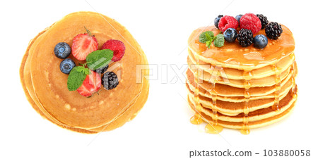 Pancakes stack with strawberry and blueberry isolated on white background. Top view. Flat lay Pancakes stack with strawberry and blueberry isolated on white background. Top view. Flat lay 103880058