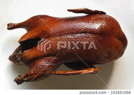 Whole smoked Duck Platter. Duck carcass on a cutting white Plate Rotating on a Turntable. Grilled wild Bird. Tradition Asian Food. Roasted Duck meat. Close Up. Gastronomy, Restaurant Meal. 103881066