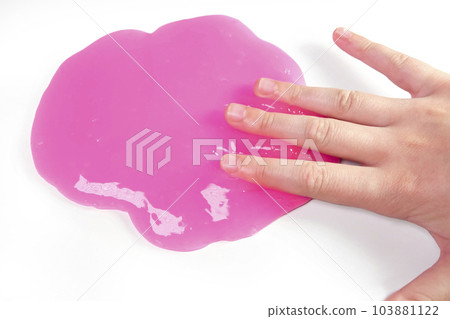 Hand Playing with textured slime on white background. Teen hand holding pink shining slime with bubbles, stretching gooey substance. Teenage Girl squeezing slime toy to the sides. Liquid toy. Handgum 103881122