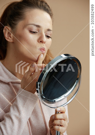 40 years old woman with herpes on lips on beige background 40 years old woman with herpes on lips on beige background 103882499