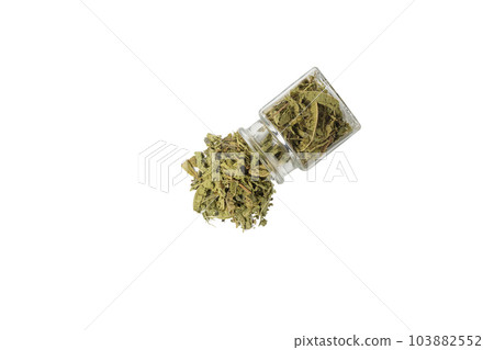 Dried leaves o Lemon verbena in latin Aloysia citrodora falling out of a glass jar isolated on white background. Medicinal herb. 103882552