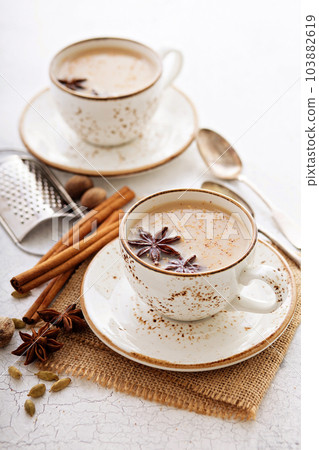 Masala tea in cup with winter spices Masala tea in cup with winter spices 103882619