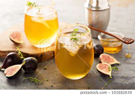 Fall refreshing cocktail with fig, honey and thyme 103882639