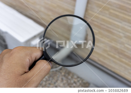 Image of checking air conditioner piping with a magnifying glass 103882689
