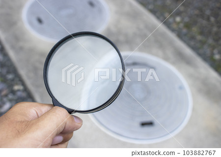Image of checking a septic tank with a magnifying glass Image of checking a septic tank with a magnifying glass 103882767