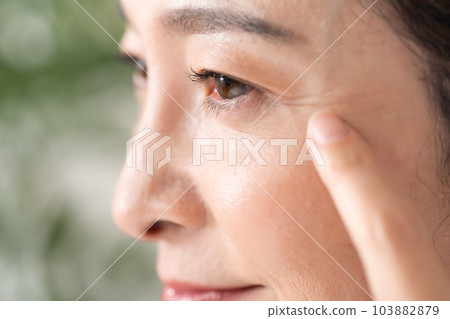 Middle-aged woman around the eyes 103882879