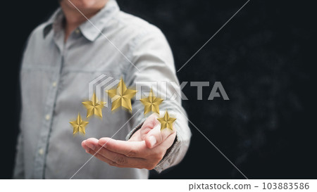 hand of customer or client holding the stars to complete five stars with copy space.Service rating,giving a five star rating.satisfaction concept. hand of customer or client holding the stars to complete five stars with copy space.Service rating,giving a five star rating.satisfaction concept. 103883586