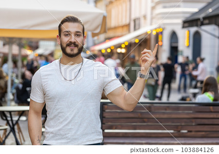 Thoughtful man pointing empty place advertising area for commercial text copy-space in city street Thoughtful man pointing empty place advertising area for commercial text copy-space in city street 103884126