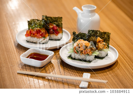 Japanese hand sushi rolls with different fish and sauce 103884911