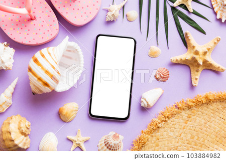 Flat lay composition with Phone and beach accessories on colored background. Smartphone with blank screen mock up with copy space 103884982