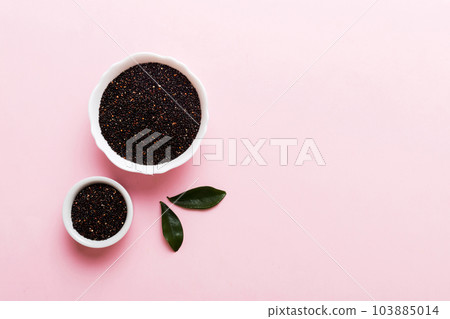 quinoa seeds in bowl on colored background. Healthy kinwa in small bowl. Healthy superfood quinoa seeds in bowl on colored background. Healthy kinwa in small bowl. Healthy superfood 103885014