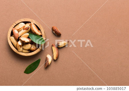 Fresh healthy Brazil nuts in bowl on colored table background. Top view Healthy eating bertholletia concept. Super foods 103885017